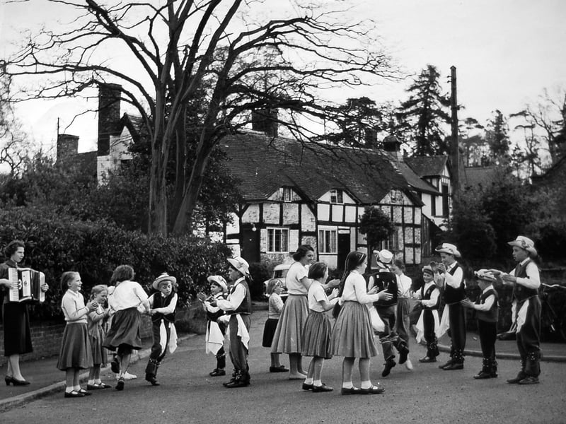 May Day was celebrated in town and country on 1 May 1959. At Tong, these black and white cottages provided an ideal backdrop for schoolchildren performing the annual dance.