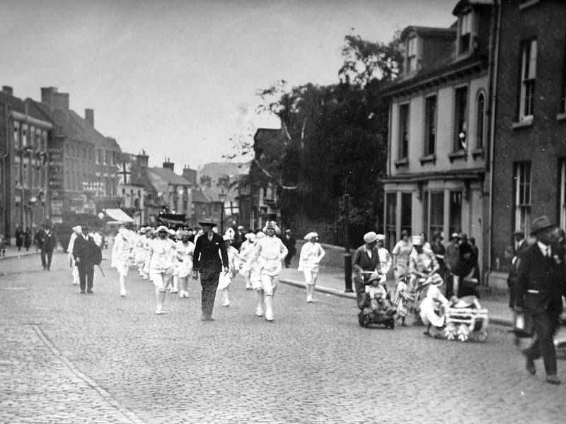This postcard comes from the collection of the late Malcolm Miles, a renowned Newport local historian. It is unused, with no postmark, message or address. A handwritten note, possibly by Malcolm, reads: “Circa 1920–1930, probably a May Day procession proceeding down St Mary Street from Lower Bar, Newport.”