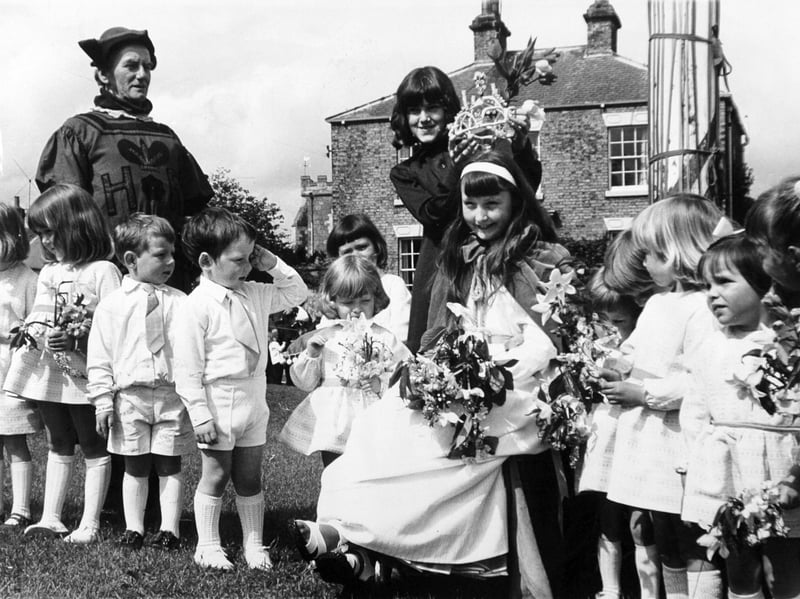 Hazel Gudgeon, 11, is crowned May Queen by her predecessor, Lynn Groves, on the village green in Aldborough, West Yorkshire, in May 1973