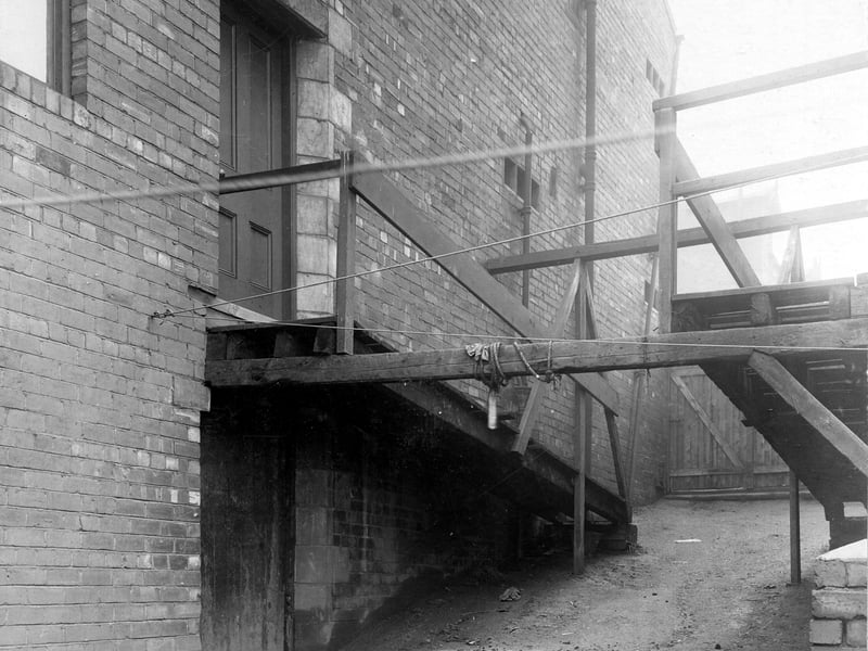 Fronting onto Cross Cardigan Mount at numbers 5 and 7, Burley Working Men's Club. This view is of the side, access ramp. An extension has been built to the back of the club. Secretary was Ernest Cowell. Pictured in November 1907.