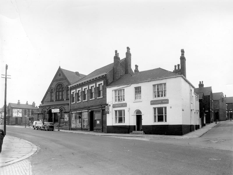 Cherry Row at the junction with Lincoln Road. This part of Burmantofts was also known as Newtown. The building with the arched doors and windows is the old Lincoln Fields Wesleyan Methodist Sunday School. The white building is the Moulders Arms. Pictured in August 1958.