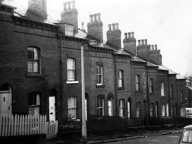 The front of a row of through terraced houses each with a private front yard. Just visible at the end of the row on the right is number 2 Queen's Road, the premises of Haycock's Grocery where a Sunblest bread delivery van is parked outside. Pictured in December 1972.