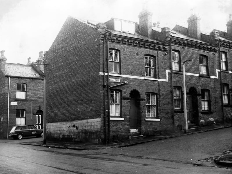 On the far left of the image is Queen's Road with Holderness Terrace visible in the background. Here a car displaying the sign British Relay TV is parked. In the foreground are two back-to-back terraced houses numbers 20 to 22 Howden Grove. Pictured in December 1972.