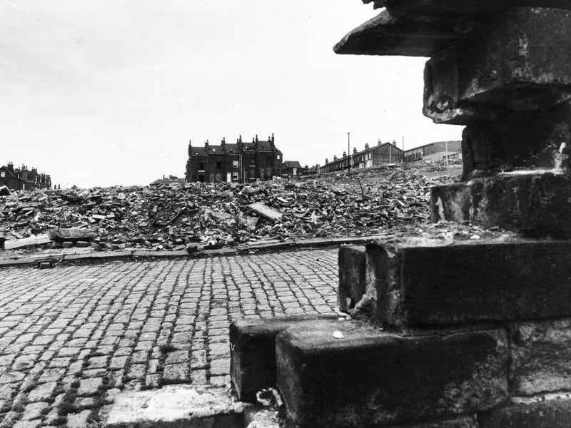 The house standing in the middle of the clearance area is the home of Emilia McCourt who was the only resident left in Howden Place by May 1976.