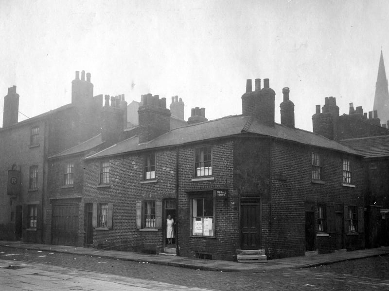 Wellington Lane in October 1930, no.9 on the corner of Mercy Street is a fish shop, business of Edna Brown. Mercy Street is on the right. The church spire is that of St. Philips, which was at junction of St. Philips Street and Wellington Street.