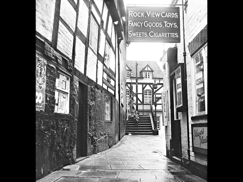 A view of Castle Walk in July 1964, featuring a sign for a novelty shop.