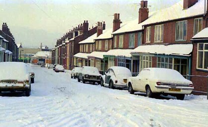 This view looks from Dorset Road along through properties on Sandhurst Road in the direction of Harehills Lane, visible in the distance.