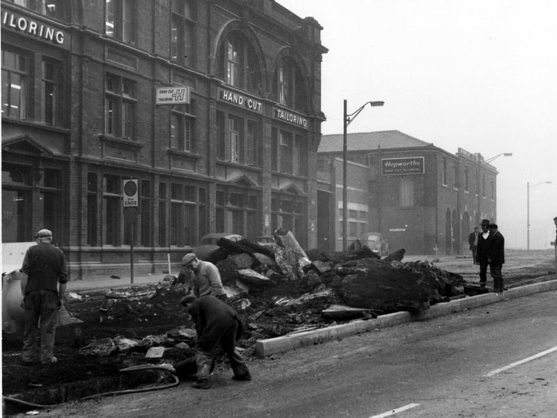 Looking north across Clay Pit Lane towards Providence Works in November 1968. Workmen are digging up the road in front of Hepworth's hand cut tailoring.