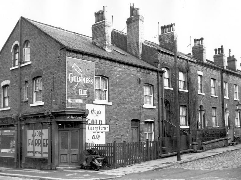 To the left are shops on Carlton Street, number 34 is 5 Morland, a butchers shop. Next 32 is Harry Farrer, licensed bookmaker. Moving right is number 1 Faith Streeet, numbers follow in sequence to 9 on the right edge. Pictured in November 1964.
