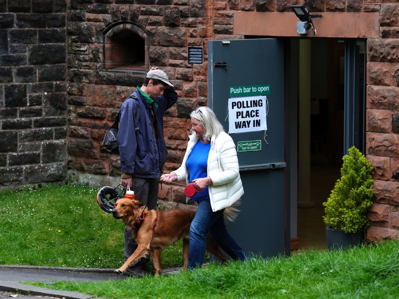 A voter and their dog dog at Pollokshields Burgh Hall, Glasgow, as voters start to cast their votes in the 2026 Holyrood elections.