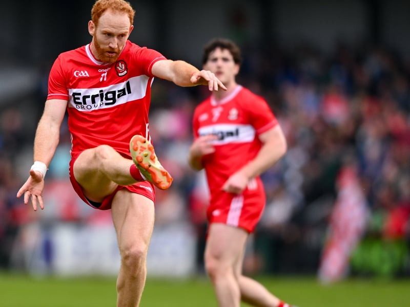 Conor Glass of Derry kicks a point.