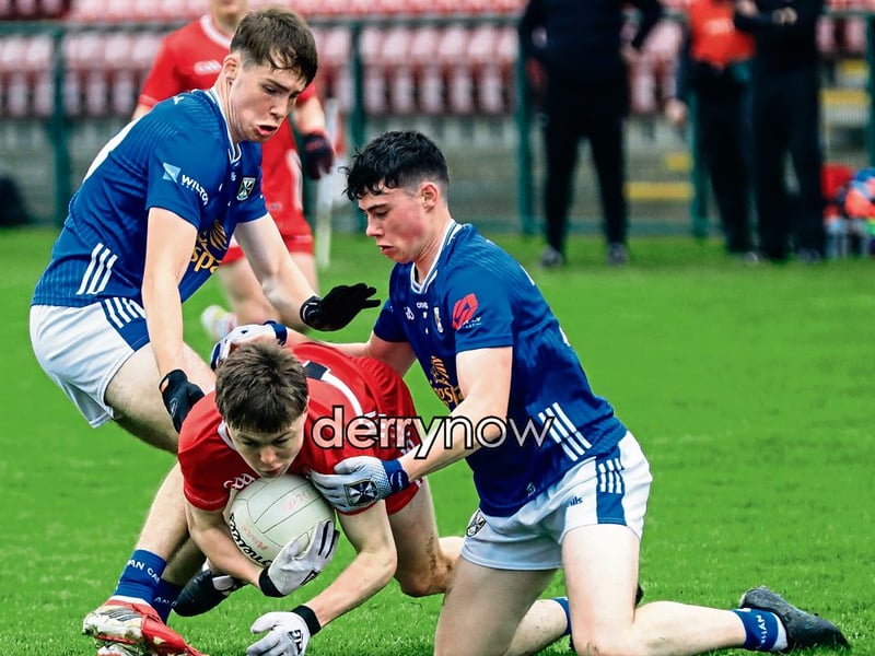 DerryTomas Devlin pulled to the ground by two Cavan players in the Electric Ireland Ulster Minor Football Championship held in Owenbeg on Saturday. (Photos - Tom Heaney, nwpresspics)