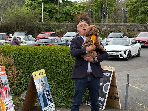 Scottish Liberal Democrats leader Alex Cole-Hamilton arriving at the polling station at Davidson's Mains Parish Church, in Edinburgh, with his dog Bramble.