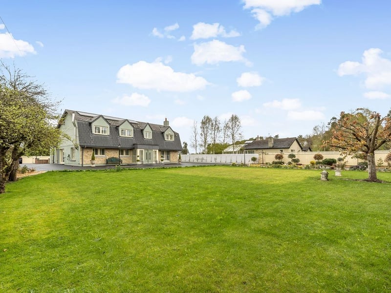Amberley, Newtown, Celbridge has come on the market with a price tag of €1,275,000. This exquisite five bedroom detached family home is set on 1.81 acres of rolling Kildare countryside. This stunning and energy efficient smart home is superbly located on Liffey View Road, Newtown, Celbridge in one of the most sought after residential locations in Kildare. Set back from the road in a peaceful and immaculately manicured country setting, Amberley is accessed through electronic gates and a sweeping driveway provides both seclusion and privacy. This exceptionally spacious and elegant family home extends to 3,250 sq. ft of expansive and light filled accommodation and has been remodeled and upgraded several times to an exceptional build specification and finish. READ MORE: Great news as plans for new Lidl in Kildare The expansive open plan kitchen with its split-level bespoke feature island, spacious dining area and sitting area is the focal point of this stunning home. The bespoke hand crafted kitchen with floor to ceiling cabinetry and high-end appliances is filled with an abundance of natural light and 2 sets of “lift to slide” doors open out to a delightful, enclosed patio area. The spacious utility and boot room is both exquisitely designed and exceptionally functional. The ground floor also features two impressive reception rooms, one of which is currently used as a master bedroom suite with walk-in wardrobe and an en-suite. Accommodation on the first floor includes 5 perfectly proportioned and beautifully styled bedrooms, four of which are en-suite. Amberley is minutes away from the bustling town of Celbridge with its wealth of amenities and services. The charming village of Ardclough and the country retreat of Lyons Estate are also on it’s door step. This truly magnificent residence offers the discerning buyer a country, tranquil lifestyle with immediate access to a bustling town on one side and a quaint village on the other and its strategic proximity to the M4 and M7 means you will be in