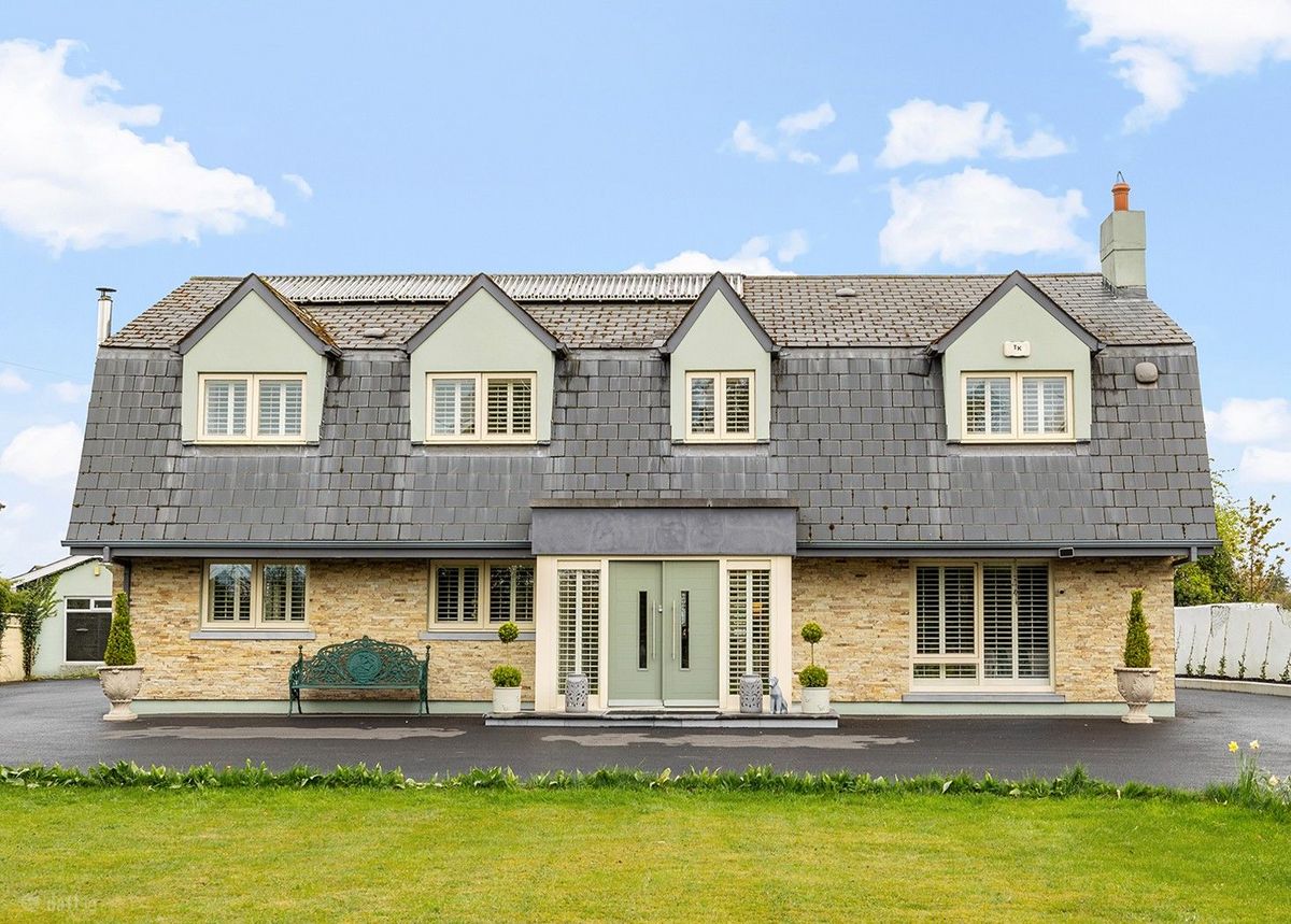 Amberley, Newtown, Celbridge has come on the market with a price tag of €1,275,000. This exquisite five bedroom detached family home is set on 1.81 acres of rolling Kildare countryside. This stunning and energy efficient smart home is superbly located on Liffey View Road, Newtown, Celbridge in one of the most sought after residential locations in Kildare. Set back from the road in a peaceful and immaculately manicured country setting, Amberley is accessed through electronic gates and a sweeping driveway provides both seclusion and privacy. This exceptionally spacious and elegant family home extends to 3,250 sq. ft of expansive and light filled accommodation and has been remodeled and upgraded several times to an exceptional build specification and finish. READ MORE: Great news as plans for new Lidl in Kildare The expansive open plan kitchen with its split-level bespoke feature island, spacious dining area and sitting area is the focal point of this stunning home. The bespoke hand crafted kitchen with floor to ceiling cabinetry and high-end appliances is filled with an abundance of natural light and 2 sets of “lift to slide” doors open out to a delightful, enclosed patio area. The spacious utility and boot room is both exquisitely designed and exceptionally functional. The ground floor also features two impressive reception rooms, one of which is currently used as a master bedroom suite with walk-in wardrobe and an en-suite. Accommodation on the first floor includes 5 perfectly proportioned and beautifully styled bedrooms, four of which are en-suite. Amberley is minutes away from the bustling town of Celbridge with its wealth of amenities and services. The charming village of Ardclough and the country retreat of Lyons Estate are also on it’s door step. This truly magnificent residence offers the discerning buyer a country, tranquil lifestyle with immediate access to a bustling town on one side and a quaint village on the other and its strategic proximity to the M4 and M7 means you will be in