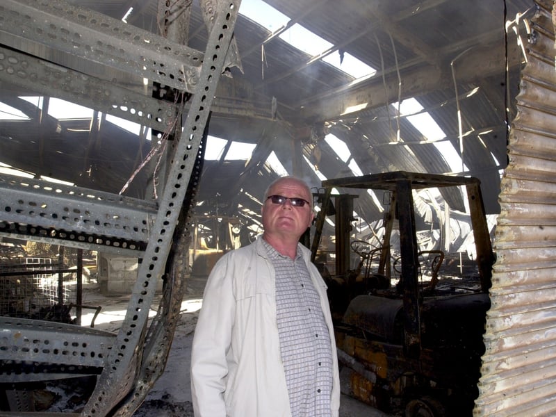 Owner Jimmy Heselden look s up at fire damage at Hesco Ltd on Knowsthorpe Gate in September 2002.