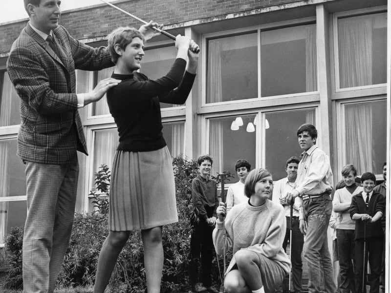 Heather Hogg, a pupil from Brinkburn County Secondary School, was receiving instruction from Shields golf professional Howard Spencer in 1967 while other members of the golfing class watch.
