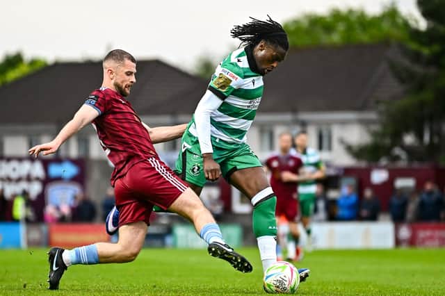 Tunmise Sobowale of Shamrock Rovers is tackled by Galway United's Aaron Bolger.