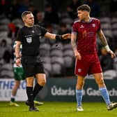Referee Kevin O'Sullivan checks on Mattie Wolfe, who pulled a goal back for Galway United early in the second-half.