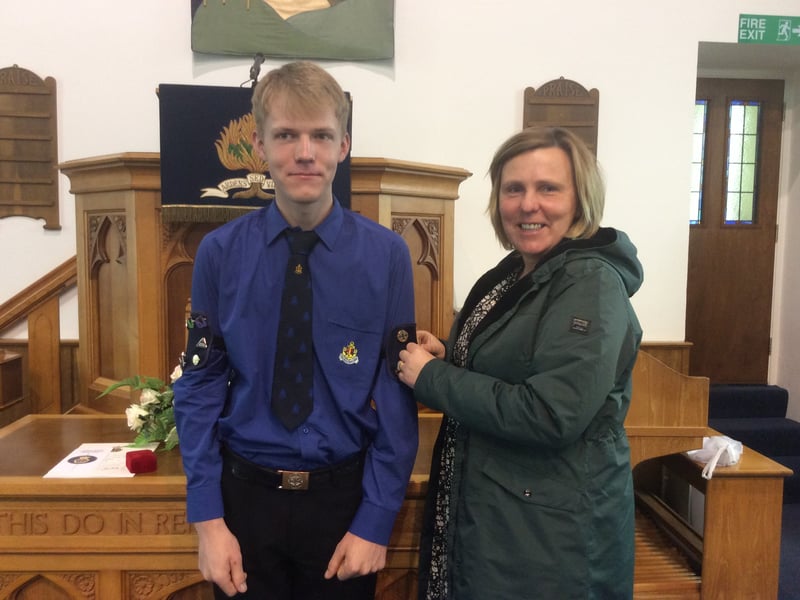 James having his Queen’s Badge pinned on by his mother Shirley.