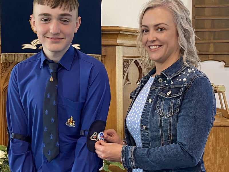 Scott having his Presidents badge pinned on by his mum Debby.