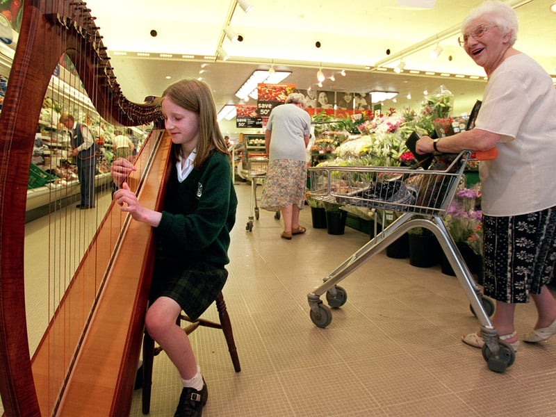 June 1999 and young Millie Womack pictured playing her harp in Sainsbury's where she had raised hundreds of pounds for the NSPCC.
