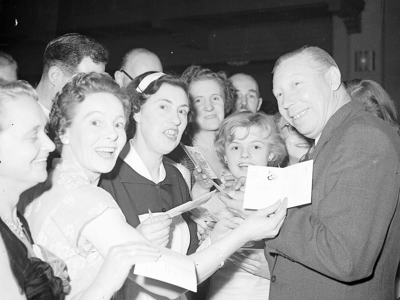 George Formby swamped by autograph hunters at the Press Ball in the Assembly Rooms in October 1956.