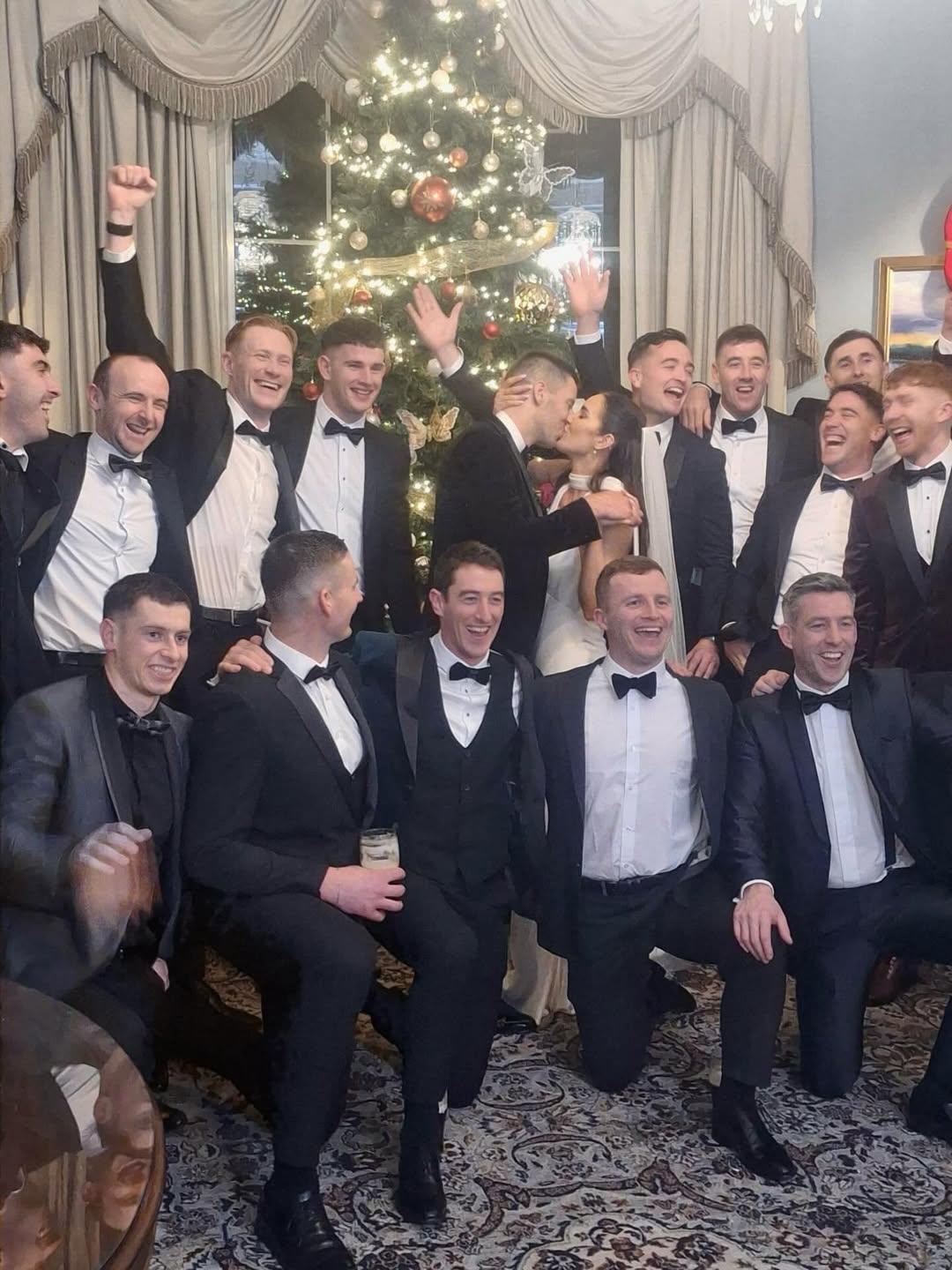 LIMERICK hurling's band of brothers joined as one to toast Dan Morrissey and his beautiful bride Yvonne Maher on their wedding day. Dan sealed the deal with a loving kiss much to the delight of his teammates (pictured above). READ NEXT: Star Limerick hurler wished ‘lifetime of love’ on his wedding day The rock at full or half back kept it local as the Lisnagry man wed Yvonne in St Joseph’s Church in Castleconnell before driving the short distance to the Castle Oaks House Hotel for the reception. Among the huge crowd in attendance were many of the men Dan has gone to battle with in the green of Limerick over the years. The Castle Oaks have shared photos of Dan and Yvonne, surrounded by Limerick hurlers, on Instagram. Yvonne looks stunning in a white silk floor length gown with a V-neckline, flowing veil and en vogue neck scarf.  A post on the hotel's Instagram page reads: “What an absolute joy it was to host the beautiful wedding of Yvonne and Dan, now Mrs & Mr Morrissey, here at Castle Oaks House Hotel. "Dan, a proud Limerick hurler from Castleconnell, and Yvonne celebrated their special day surrounded by family and friends in a truly memorable winter wedding.”  It continued: “Elegant red accents ran beautifully throughout the day, from stunning red roses to thoughtful details, adding a rich, romantic touch that perfectly complemented the season. Their celebration was filled with love, laughter and unforgettable moments, all set against the romantic riverside backdrop of our venue.” The post by the Castle Oaks concludes by saying: “We feel truly honoured to have been part of such a special occasion and wish Mr & Mrs Morrissey a lifetime of happiness, love and cherished memories as they begin this exciting new chapter together.”  For more pictures, click 'Next'