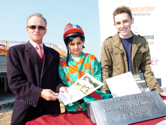 Champion Jockey Pat Eddery was the guest of honour at a ceremony at Doncaster Racecourse where a time capsule was buried containing St. Leger memories. He is pictured here along with competition winners Laraib Saeed, ten, of Hexthorpe primary school and Jamie Hogue, 15, of Balby Carr school.
