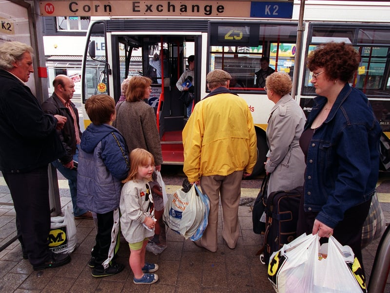 Passengers board a bus at the Corn Exchange.
