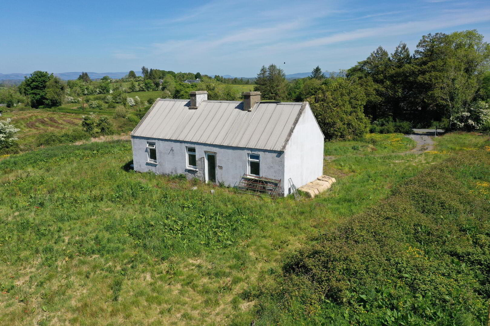 Lavender Cottage in Leitrim, Corriga has gone up for the astonishingly low price of €50,000.   The property is partially renovated, with a new corrugated roof, a water connection and a septic tank on site. A savvy buyer will see that there is much to be desired in the condition of the house’s walls.  Auctioneer Joe Brady said this cottage is a prime candidate for the Vacant Property Refurbishment Scheme and that “there are things that aren’t visually apparent” done to the property which add value to the listing.  “Put another €100,000 into the house, and you’ll have a lovely home for €150,000”, said the seller.   Read More: Leitrim Eurovision winner weighs in on RTÉ boycott of competition if Israel competes Brady estimates that the house was built in the 1950s, and said that there has been a large interest in the property since it has gone on the market.  He estimates that the property could sell for up to €60,000.  The large 1.5 acre site is located in a “rural and tranquil setting”, close to the Cavan border and Carrick-on-Shannon.  The house is a two kilometre walk from the village of Aughavas, which is home to a local pub, church, sports ground and national school.  The listing on Daft.ie reads: “The elevated site gives excellent views of Sliabh an Iarainn and the surrounding countryside." “Accommodation in brief comprises entrance hallway, living area, three potential bedrooms and potential for bathroom.” REA Brady auctioneers considers the run-down house to be a “gem”.