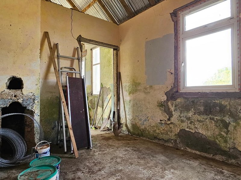 Lavender Cottage in Lavender Cottage in Leitrim, Corriga has gone up for the astonishingly low price of €50,000. The property is partially renovated, with a new corrugated roof, a water connection and a septic tank on site. A savvy buyer will see that there is much to be desired in the condition of the house’s walls. Auctioneer Joe Brady said this cottage is a prime candidate for the Vacant Property Refurbishment Scheme and that “there are things that aren’t visually apparent” done to the property which add value to the listing. “Put another €100,000 into the house, and you’ll have a lovely home for €150,000”, said the seller. Read More: Leitrim Eurovision winner weighs in on RTÉ boycott of competition if Israel competes Brady estimates that the house was built in the 1950s, and said that there has been a large interest in the property since it has gone on the market. He estimates that the property could sell for up to €60,000. The large 1.5 acre site is located in a “rural and tranquil setting”, close to the Cavan border and Carrick-on-Shannon. The house is a two kilometer walk from the village of Aughavas, which is home to a local pub, church, sports ground and national school. The listing on Daft.ie reads: “The elevated site gives excellent views of Sliabh an Iarainn and the surrounding countryside." “Accommodation in brief comprises entrance hallway, living area, three potential bedrooms and potential for bathroom.” REA Brady auctioneers considers the run-down house to be a “gem”.