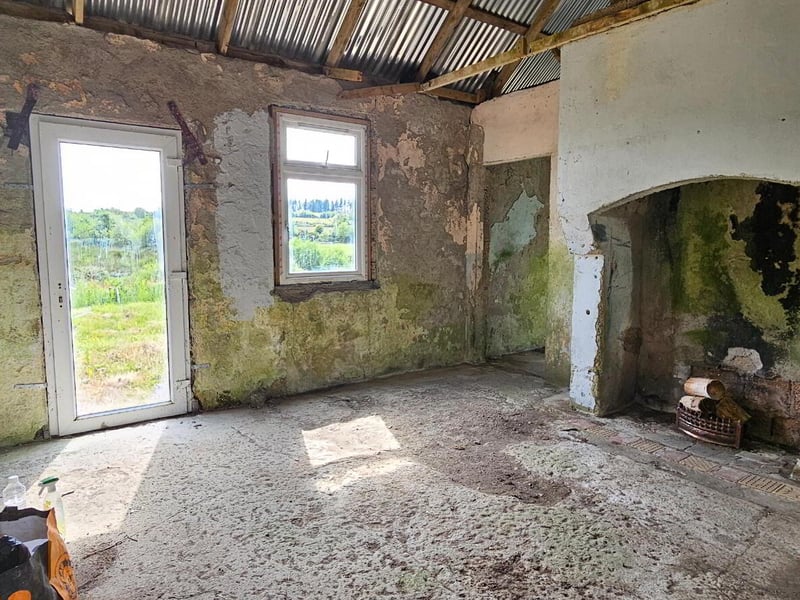 Lavender Cottage in Lavender Cottage in Leitrim, Corriga has gone up for the astonishingly low price of €50,000. The property is partially renovated, with a new corrugated roof, a water connection and a septic tank on site. A savvy buyer will see that there is much to be desired in the condition of the house’s walls. Auctioneer Joe Brady said this cottage is a prime candidate for the Vacant Property Refurbishment Scheme and that “there are things that aren’t visually apparent” done to the property which add value to the listing. “Put another €100,000 into the house, and you’ll have a lovely home for €150,000”, said the seller. Read More: Leitrim Eurovision winner weighs in on RTÉ boycott of competition if Israel competes Brady estimates that the house was built in the 1950s, and said that there has been a large interest in the property since it has gone on the market. He estimates that the property could sell for up to €60,000. The large 1.5 acre site is located in a “rural and tranquil setting”, close to the Cavan border and Carrick-on-Shannon. The house is a two kilometer walk from the village of Aughavas, which is home to a local pub, church, sports ground and national school. The listing on Daft.ie reads: “The elevated site gives excellent views of Sliabh an Iarainn and the surrounding countryside." “Accommodation in brief comprises entrance hallway, living area, three potential bedrooms and potential for bathroom.” REA Brady auctioneers considers the run-down house to be a “gem”.