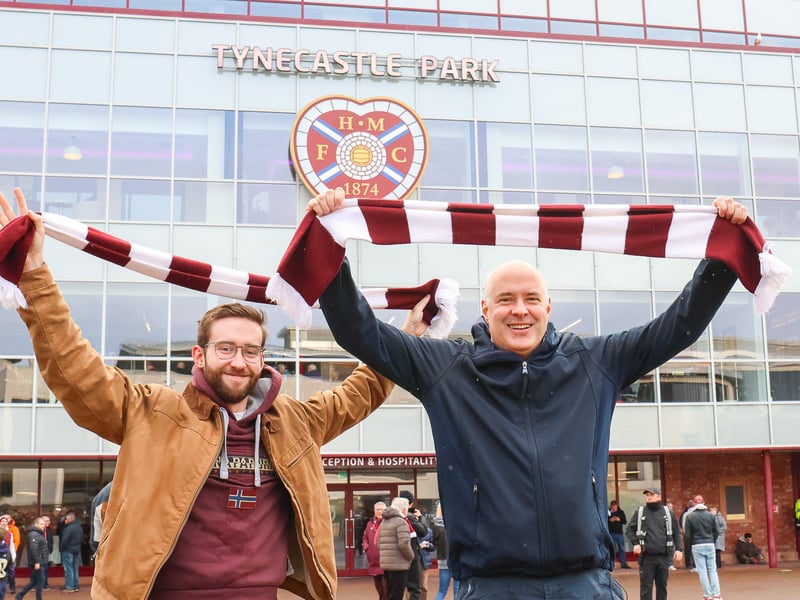 Luke and John hold their scarves high.