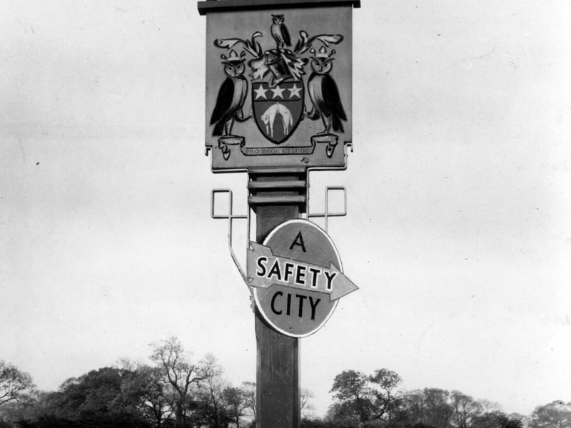 The Leeds coat of arms with "a safety city" sign underneath at the Leeds Boundary at Seacroft. Pictured in August 1949.