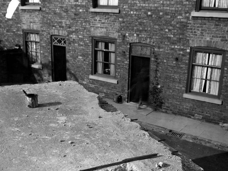The damaged roof of outside toilets in Backhouse Yard in August 1942.