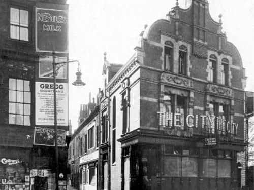 On the left, no.15 Woodhouse Lane, premises of Percy Charles Holmes, newsagent. the front wall of the shop has posters advertising 'Nestle's Milk, Morecambe holidays, evening classes teaching Gregg shorthand system'. Pictured in September 1927.