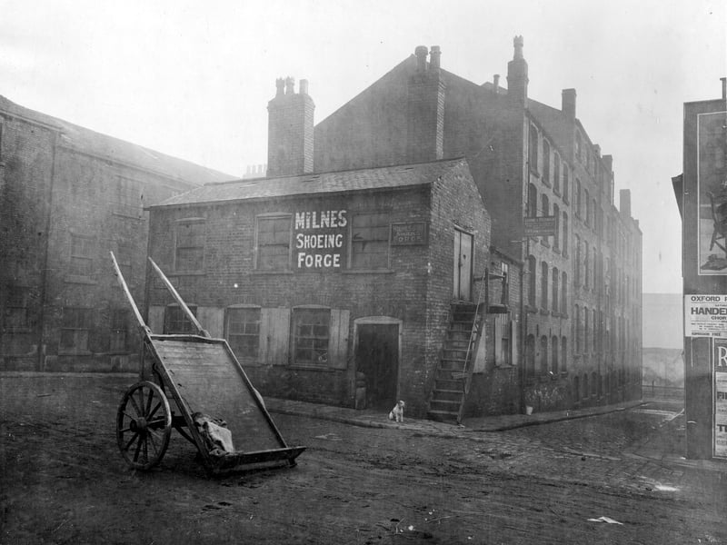 This forge business of Milnes and son, was on Virginia Cross Street. On the left is Virginia Street, to the right Back Virginia Street. The mill had various companies operating from there, including Morris and Mencher rag merchants, B Winn furniture maker and Levene and Feldman, tailors. Pictured in November 1927.
