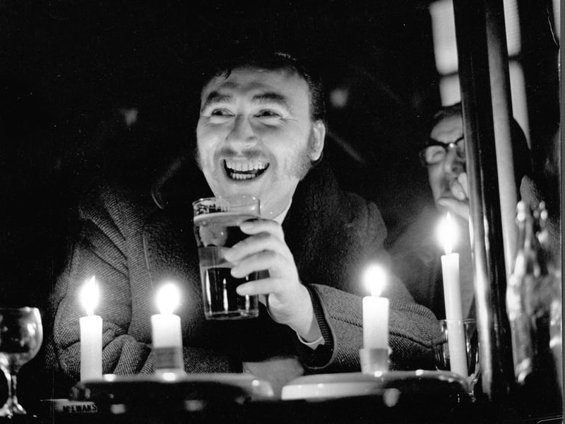 A regular at Gordon's Bar, Glasgow, enjoys a pint by candlelight during a power cut amid the miners' strike in 1972