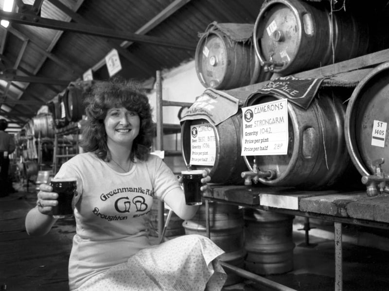 Liz Neil, from the Greemantle pub, serves up real ale at the Scottish Traditional Beers exhibition held in the Caledonian Brewery, Slateford Road Edinburgh, in May 1981
