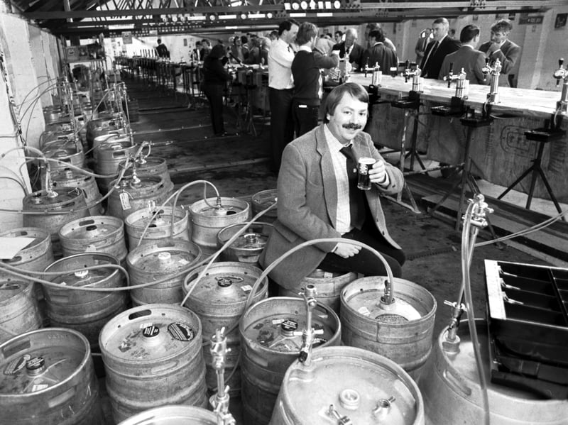 A beer drinker sitting among the barrels at the CAMRA (Campaign for Real Ale) festival at Caledonian Brewery, Edinburgh, in May 1985