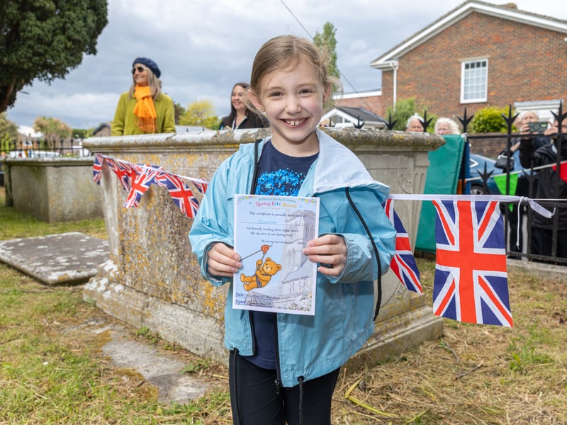 Summer waiting for her teddy bear - and holding a certificate.