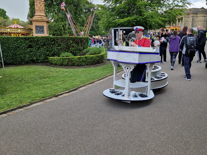A mobile pianist playing Elton John tunes around Weston Park for the may Fayre. Photo: David Kessen, Iconic Media