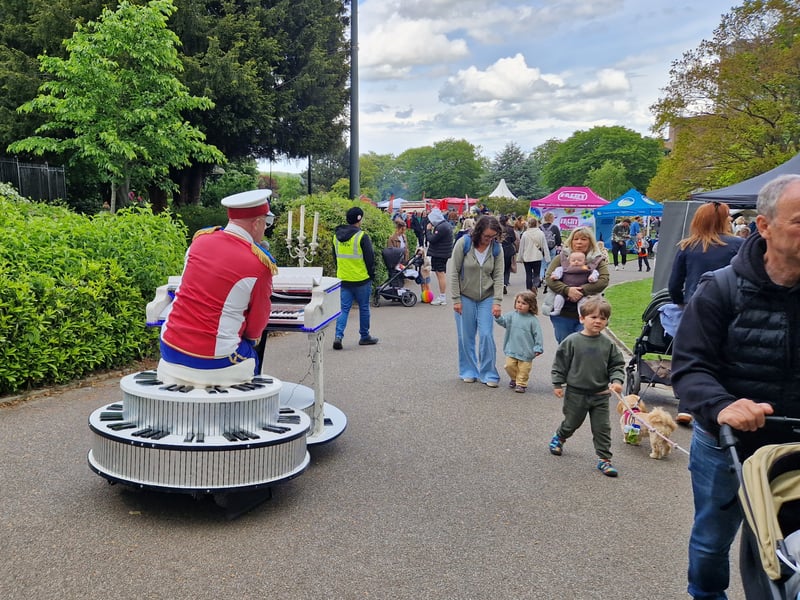 Visitors hear Elton John songs from a wandering piano at the May Fayre, at Weston Park. Photo: David Kessen, Iconic Media