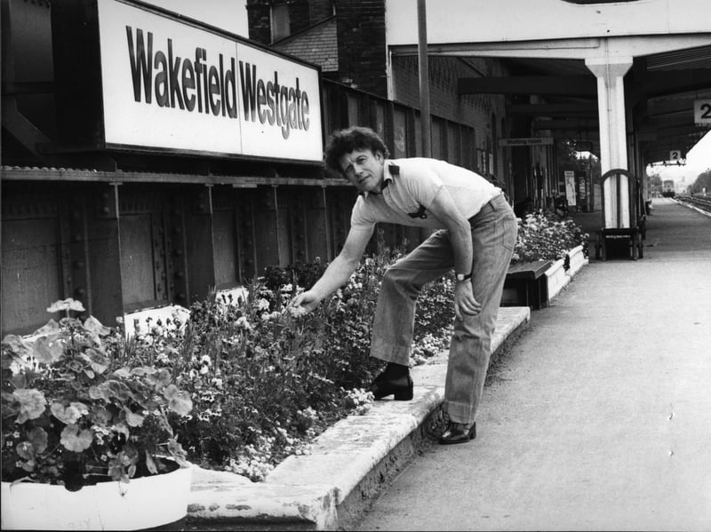 Gas board fitter Ernest Brice tends the floral displays the keen gardener has provided free of charge at Wakefield Westgate railway station in August 1980