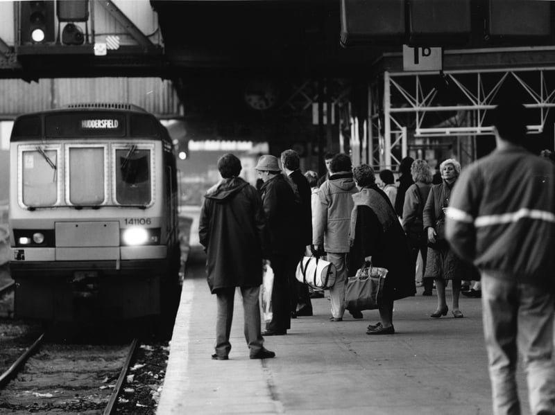 Passengers on the platform at Sheffield railway station in March 1991, as the train to Huddersfield approaches