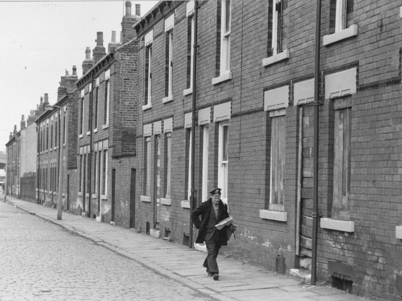Postman delivering on a cobbled street in April 1979.