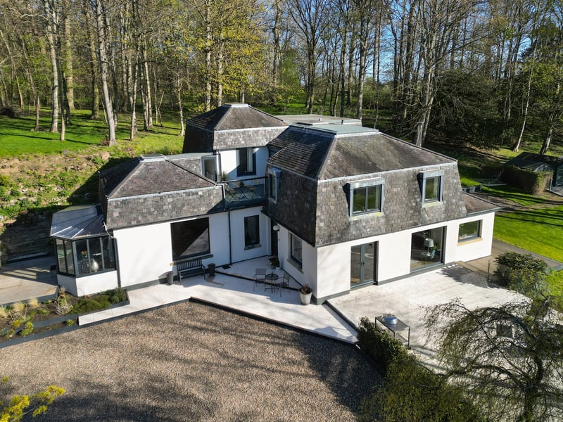Orchard Wood is set within stunning gardens and grounds of approximately 1.7 acres with sweeping lawns, mature woodland and the Belsis Burn running along the southern border. A private driveway off the shared lane leads to a modern detached double garage with underfloor heating and an extensive gravelled parking area.