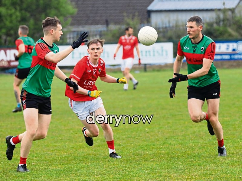 Doire Trasna's John McKiverigan passes the ball to his team mate as the game progresses against Sean Dolans. 