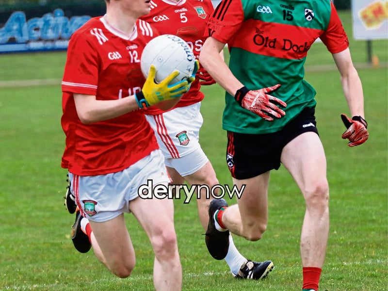 Sean Dolans Oisin Porter presses forward with the ball as Doire Trasna's Oran Donnelly moves in.